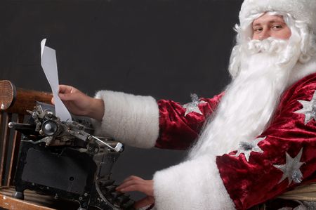 Santa Claus typing a letter on an typewriterの写真素材