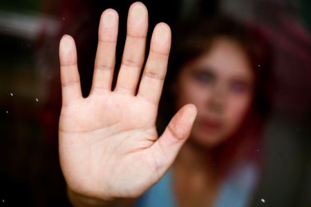 Lonely women In the glass. Hand close up.の写真素材