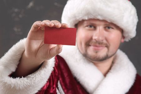 Santa Claus showing a red cardの写真素材