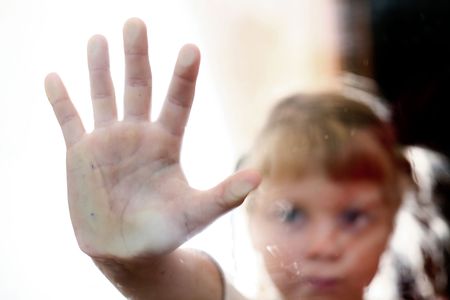 Portrait of a young girl outside the windowの写真素材