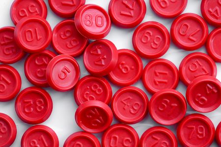 An image of red bingo game chips on cardの写真素材