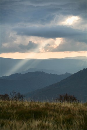 An image of sunrays going through cloudsの写真素材