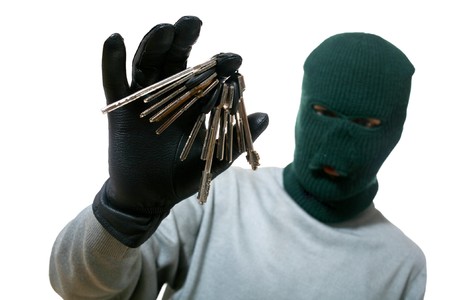 An image of a man in dark mask with a bunch of keys