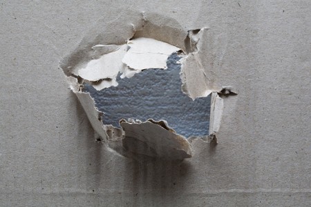An image of hole in a piece of cardboardの写真素材