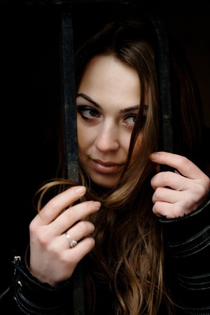 Stock photo: an image of a sad girl looking through the gatesの写真素材