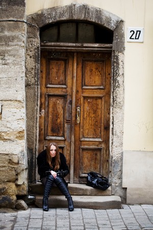 Stock photo: an image of a woman sitting at the doorの写真素材