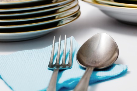 Stock photo: an image of a spoon and a fork on blue napkin
