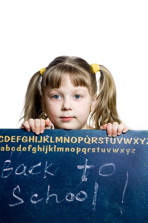 An image of a schoolgirl looking from behind a blackboardの写真素材