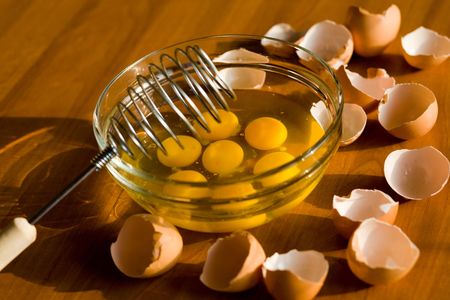 A glass plateful of eggs while an omelette preparing