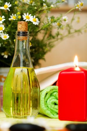 An image of a bottle of oil and a candleの写真素材
