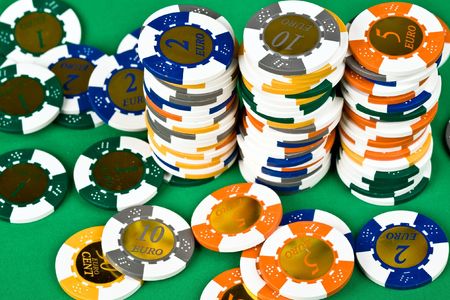 An image of poker chips on green tableの写真素材
