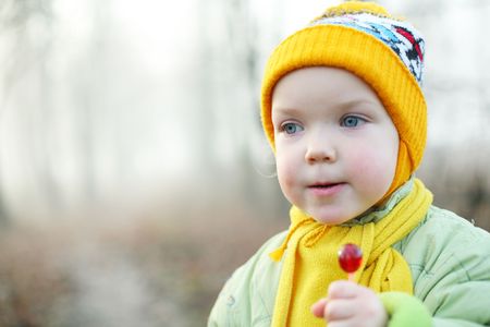 An image of a little girl with a candyの写真素材