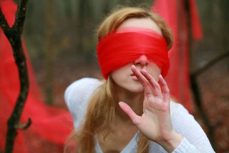 An image of blindfolded woman in the forestの写真素材