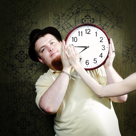 An image of a man with a big clock の写真素材