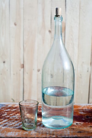 An image of a half-full bottle and a glassの写真素材