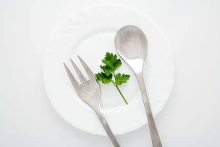 An image of a plate with spoon and fork on itの写真素材