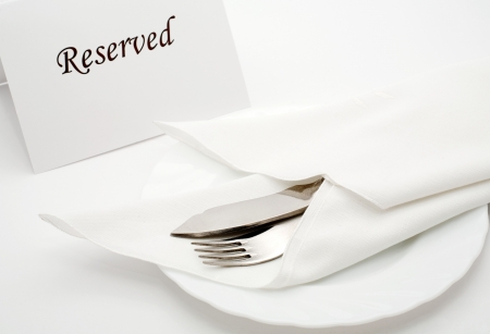 An image of fork and kife in napkin on the tableの写真素材