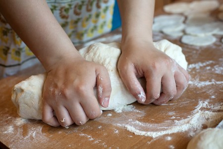 An image of hands making dough on the tableの写真素材