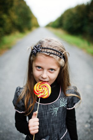 An image of little girl with candy in his handの写真素材