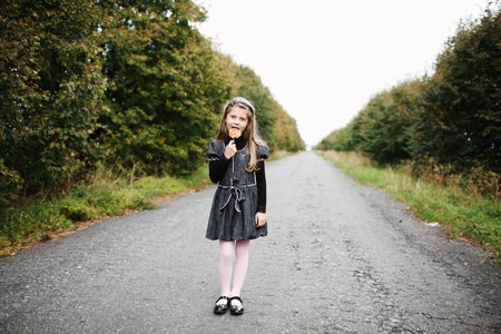 An image of little girl wit candy in his handの写真素材