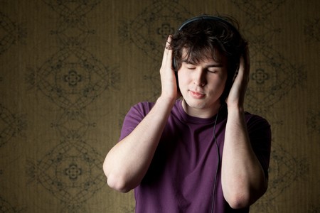 A young man listening to music in headphonesの写真素材