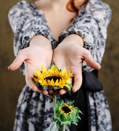 An image of young woman with sunflowerの写真素材