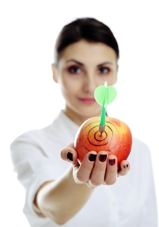 An image of nice girl holding apple with dart.の写真素材
