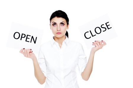 An image of young businesswoman holding sheets of papper with inscriptions OPEN and Closeの写真素材
