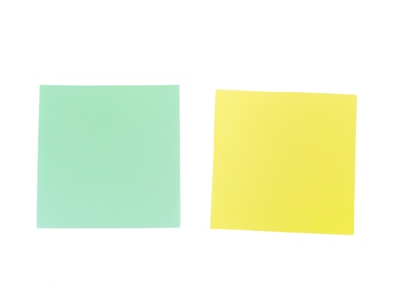 An image of yellow and green sticky notes on whiteの写真素材