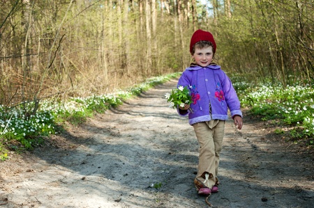 An image of a little girl walking in the forestの写真素材