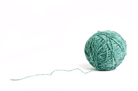 An image of a ball of green yarn on white backgroundの写真素材