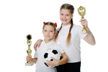 Happy girls holding trophies.の写真素材