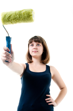 Image of young girl in black t-shirt with roller brush. Shutting in studioの写真素材