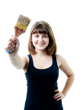 Image of young girl in black t-shirt with brush. Shutting in studioの写真素材