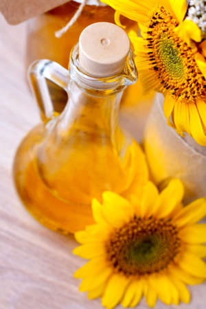 Pitcher with sunflower oil, and flowersの写真素材