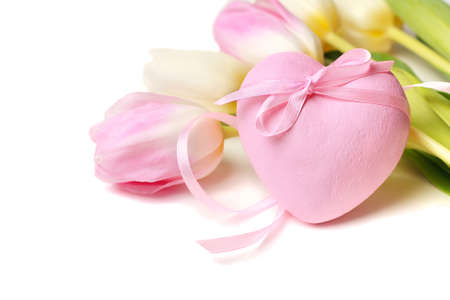 Pink heart with ribbon and flowers  On a white background