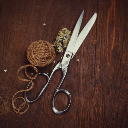 old scissors, on the wooden tableの写真素材
