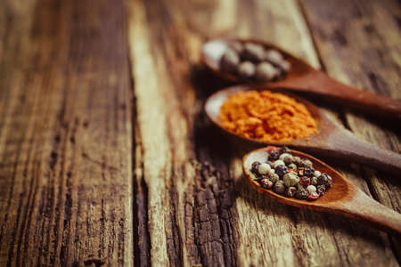 Three wooden spoons with spices, close-upの写真素材