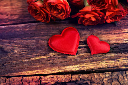 Two small red heart on wooden surfaceの写真素材