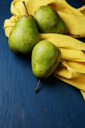 Three juicy pears on a blue wooden backgroundの写真素材