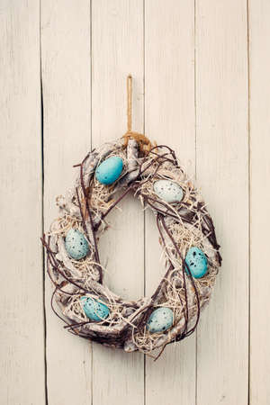 Easter egg wreath on a wooden backgroundの写真素材