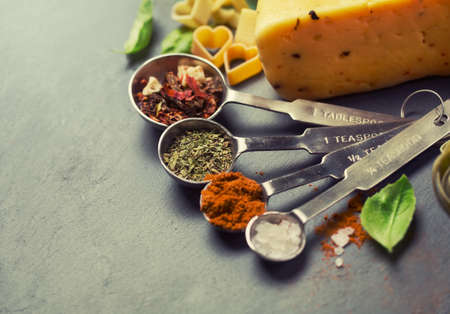spices for Italian pasta in metal measuring spoonsの写真素材