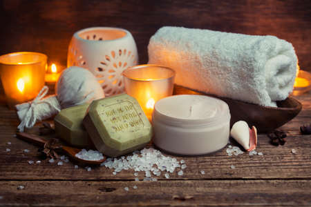 Body lotion, soap and towel on a wooden surface, Spa still life