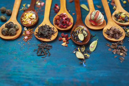 Dry tea with in wooden spoons. Selective focus