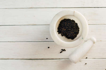 Black pepper in a mortar, a top viewの写真素材