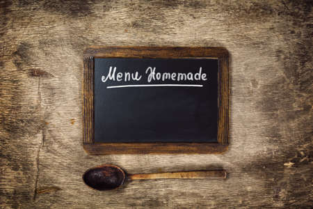 Wooden spoon and Black board on with text - Menu Homemade. Top viewの写真素材