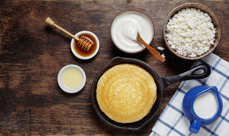 pancakes with cottage cheese, sour cream and honey on wooden backgroundの写真素材
