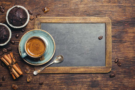 Espresso with chocolate cupcake. Rustic background with vintage blackboardの写真素材