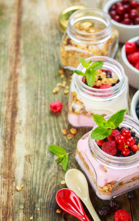 Muesli and yogurt with berries on wooden backgroundの写真素材