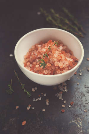 Pink salt  with thyme on a dark backgroundの写真素材